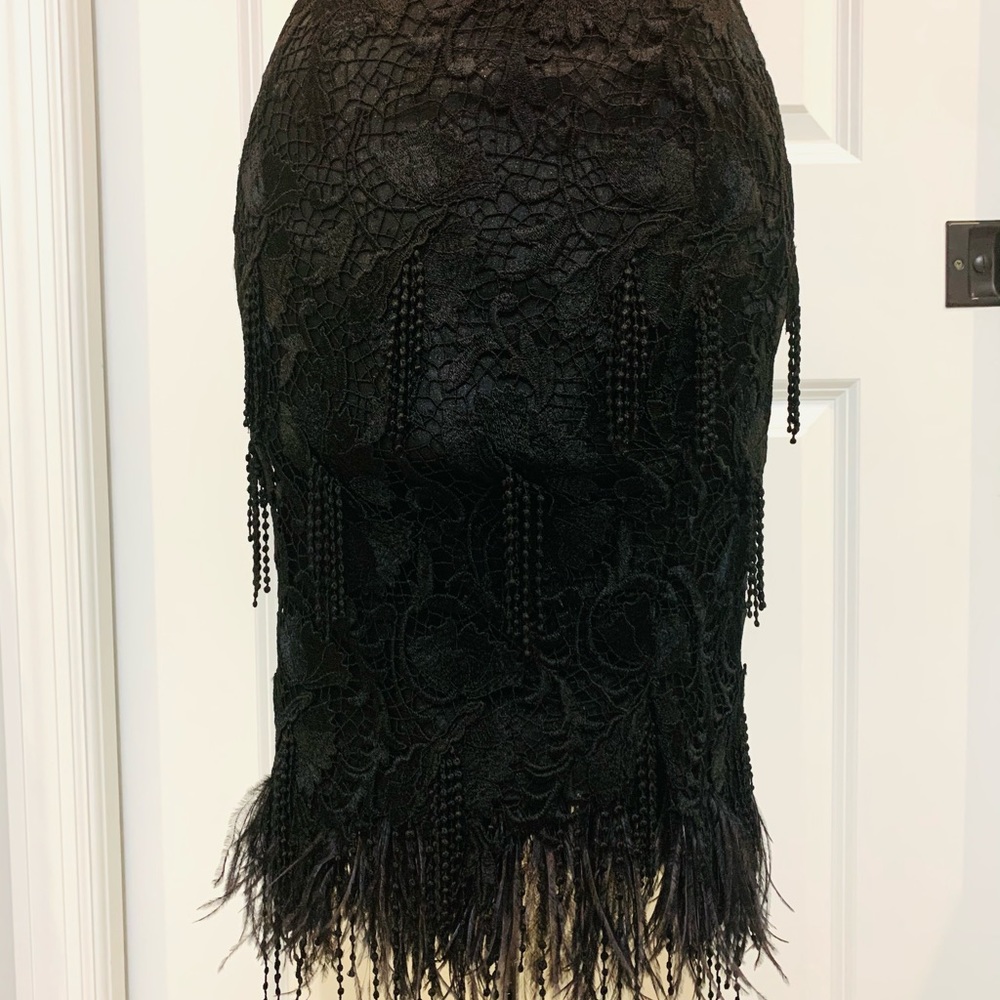 Lase skirt with ostrich feathers.